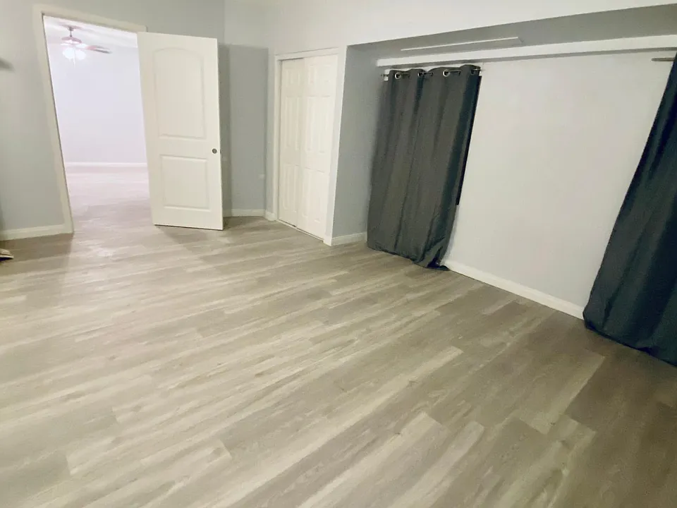 Inside bedroom. New paint, new floors, new doors, new curtains.