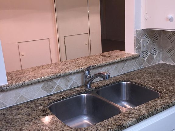 Kitchen facing nook Granite Counter tops tile back splash stainless steel sink