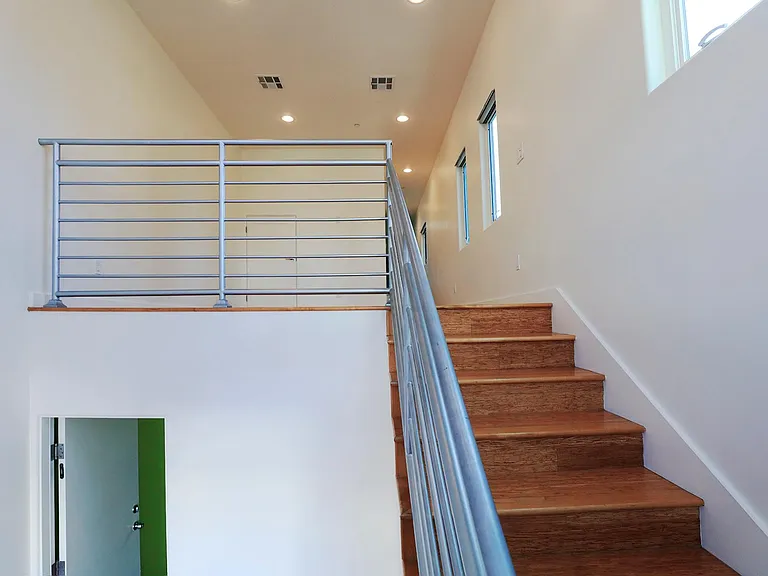 Passage Door from Garage and Entry Staircase Going Up to Living Room