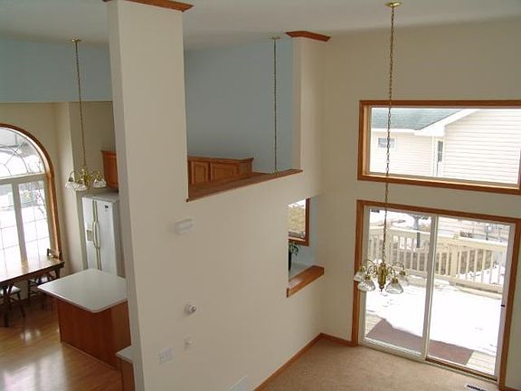 View of main floor from stairway note sliding glass door to deck