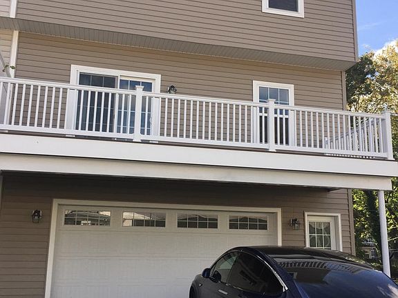 rear of house w/ deck over 2 car garage