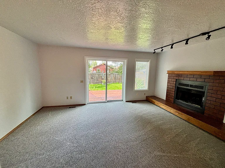 Open living room with a fireplace.