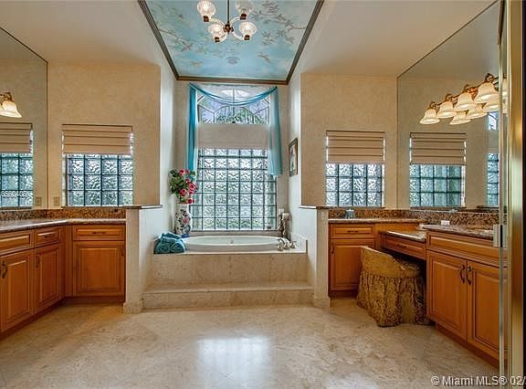 ELEGANT MASTER BATHROOM WITH DOUBLE SINK AREA AND WHIRLPOOL