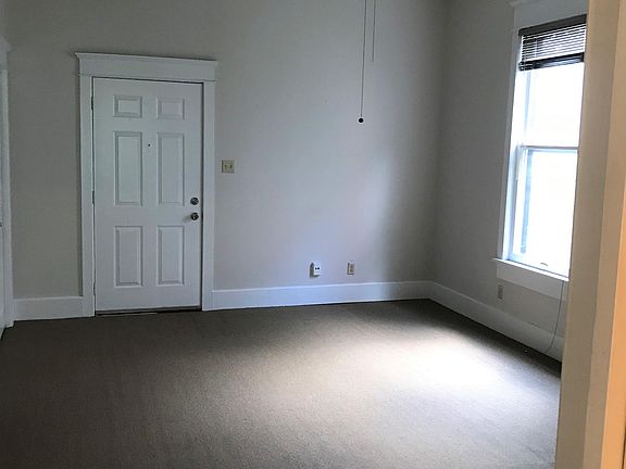 Bedroom view with ceiling fan and two closets for storage