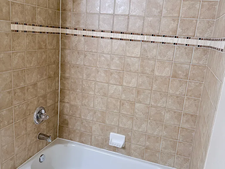 tiled and full size bathtub