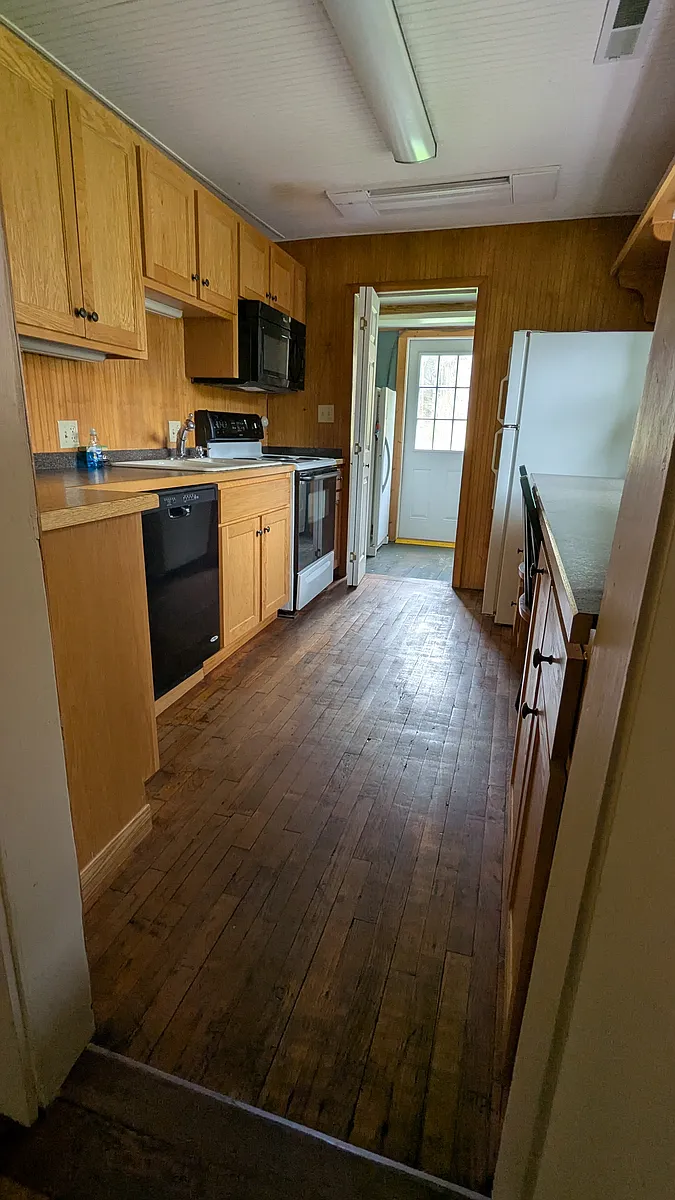 galley kitchen with bar seating - 835 Dobbins Rd