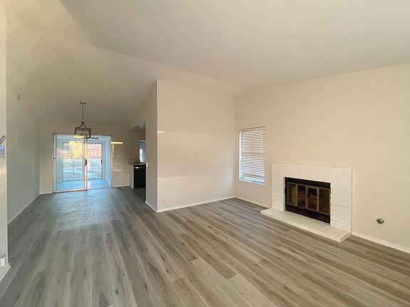 The living room features a cozy fireplace with lots of natural light.