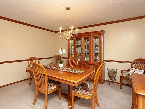 The stunning formal dining room is accentuated by the chair rail and crown molding and is perfect for entertaining.