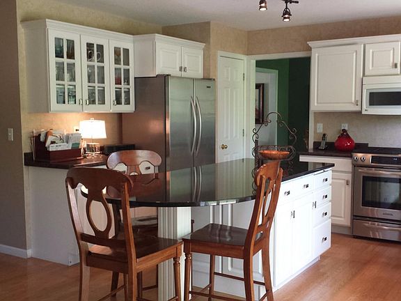 Crisp white kitchen, granite top island