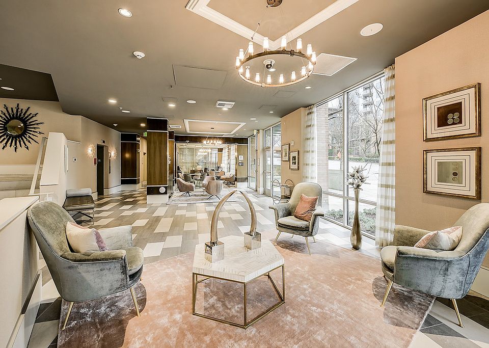 Lobby with hard surface flooring and floor to ceiling windows.