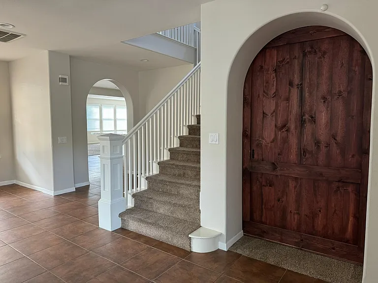 foyer and study/exercise room with barn door