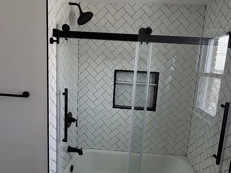 Contemporary tub shower with matching black fixtures
