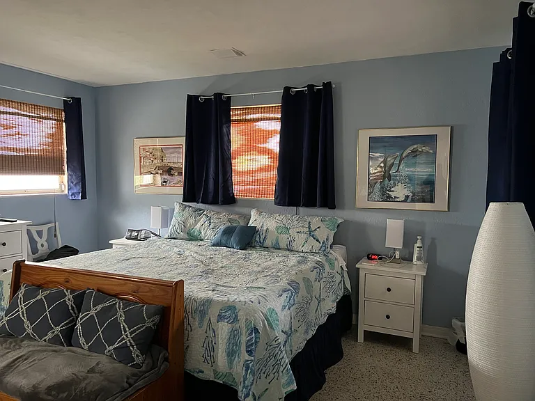 Master bedroom with king bed and bathroom with walk in shower.