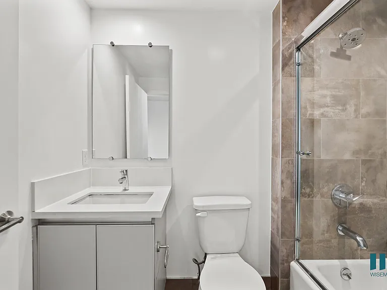 Bathroom with Shower Bath with Glass Door and Vanity Cabinet Storage