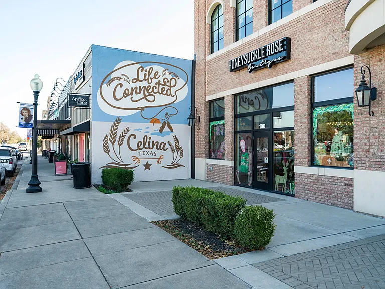 A Downtown Celina streetscape featuring local boutiques and a signature mural, reflecting the area's character and strong sense of community.