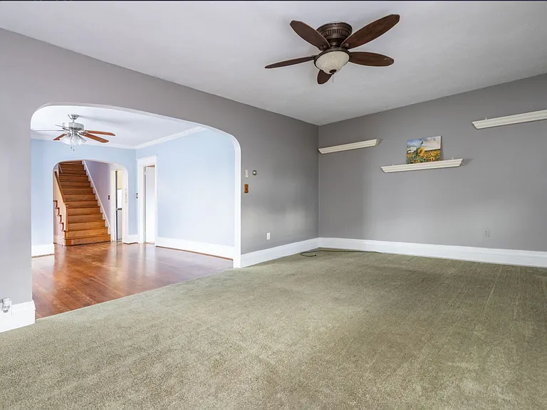Enter into large living room. Continue through arch to dining room.