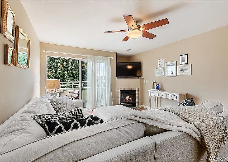 Open floorplan living room expands onto patio through extra wide sliding glass door