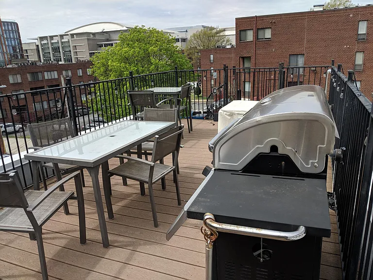 View of Convention Center, United House of Prayer dome, and more.
Grill and deck furniture in shared space.