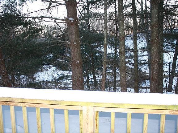 Back porch with wooded view of our neighbor's stables. So pe