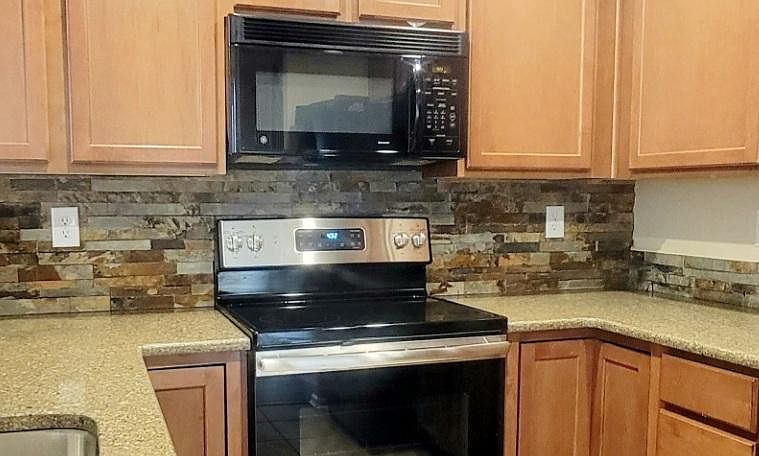Stone backsplash. Quartz counters.