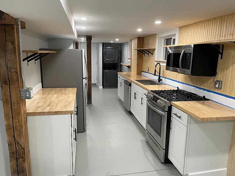 Very large cook's kitchen with matte black hardware, soft close cabinets, beautiful butcher block countertops