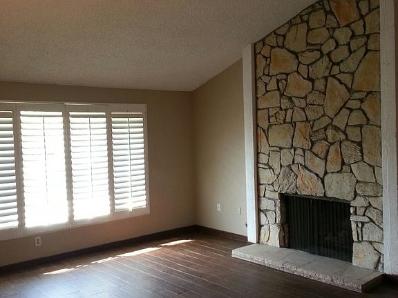 Living Room features Plantation Shutters & Fireplace