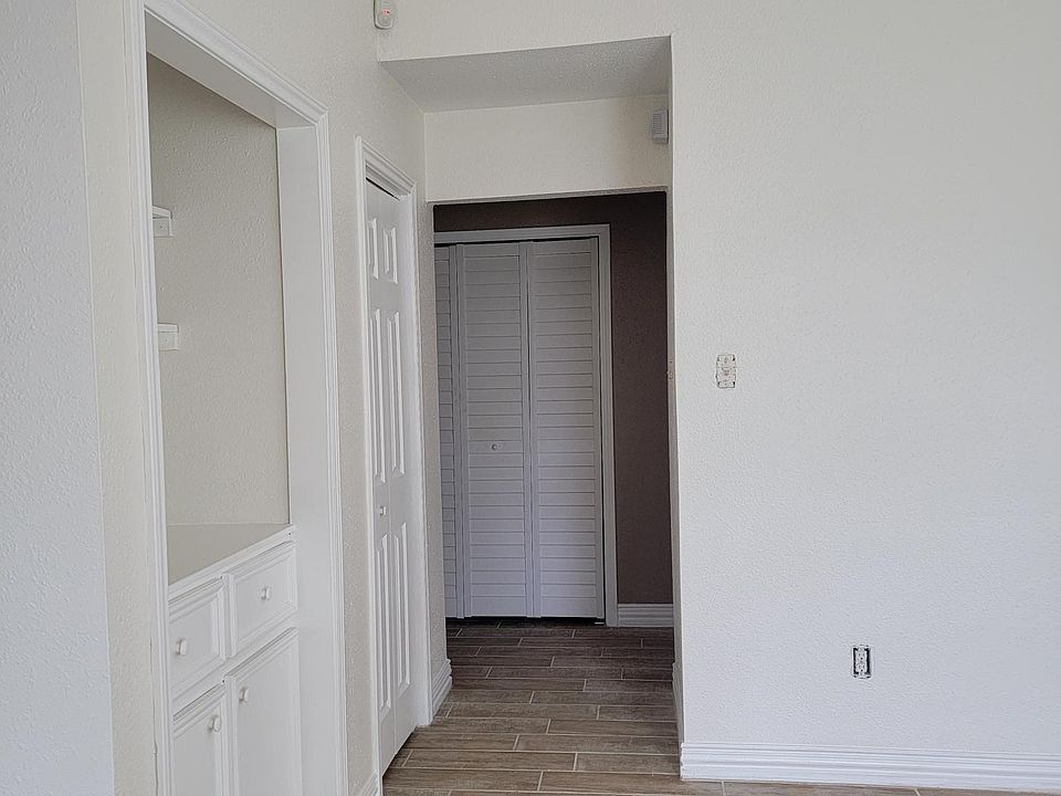 Living Room Leading to Hallway, Bedrooms, and Laundry Room with Washer and Dryer Included.