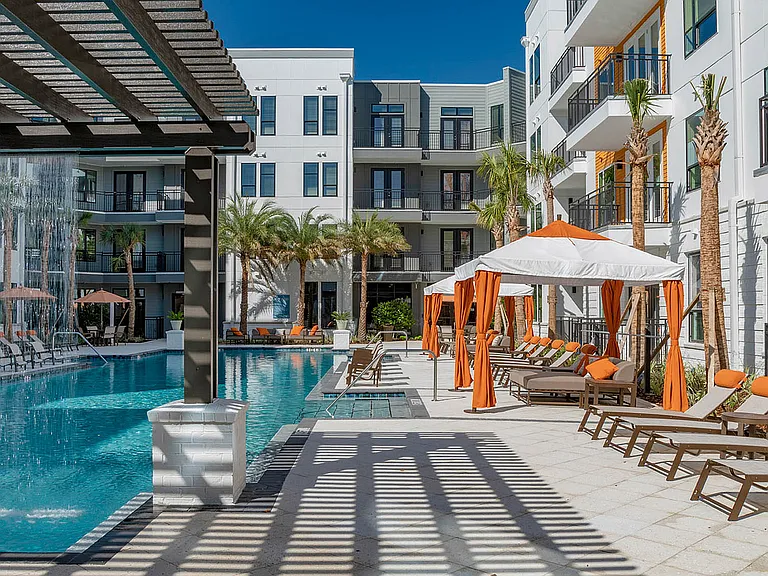 Experience serene poolside relaxation at this luxurious apartment complex.