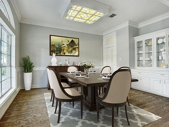 Elegant Dining room features transit window, picture chair-rail, crown molding and built-in dining hutch. (virtually staged)