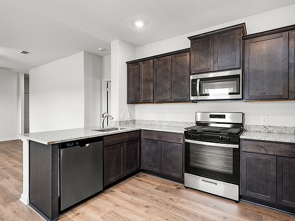 The kitchen of the Hawthorn has sprawling granite countertops.