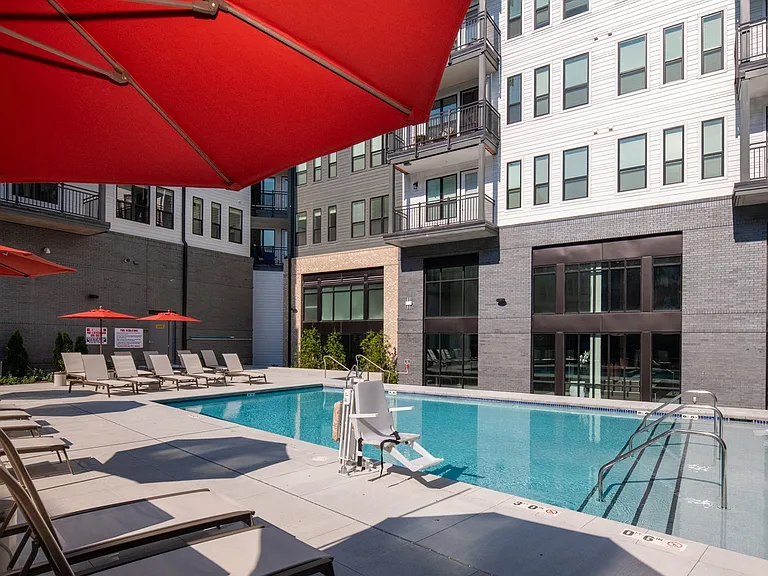Relax by the resort-style pool with shaded loungers and modern amenities.