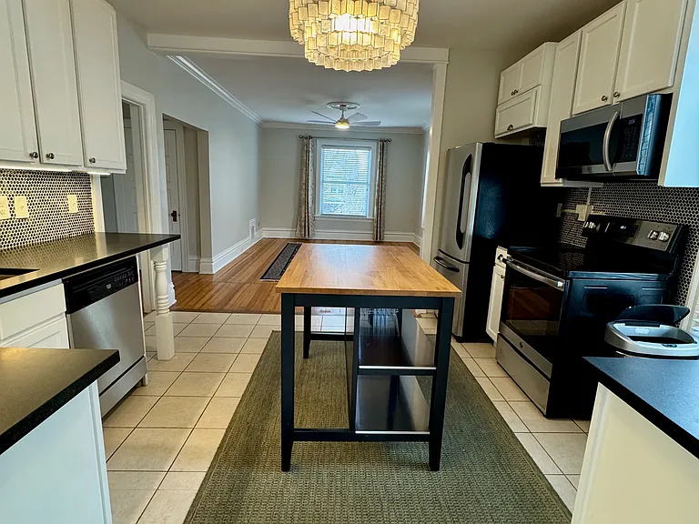 Kitchen open to living room, island has seating for 2 barstools