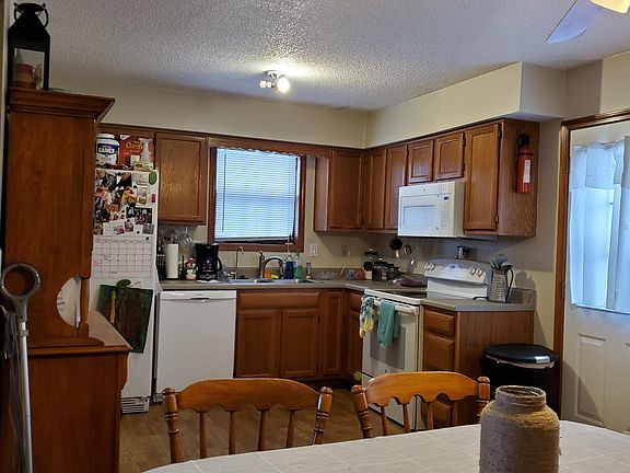 Large kitchen with open floor plan including a dining area.
