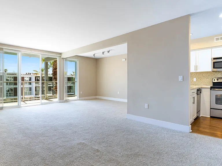 Carpeted Living Room with Balcony
