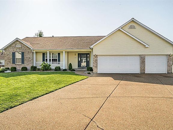 1970 Royal Heir Drive beautifully landscaped with a spacious front porch.