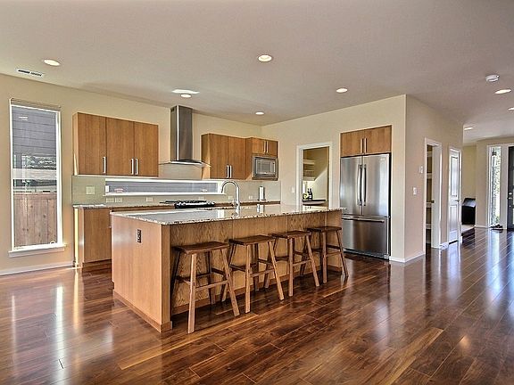 Kitchen has granite countertops, quiet close cupboards, top-end stainless steel appliances including a French door fridge, microwave, dishwasher, gas range/oven, as well as a garbage disposal