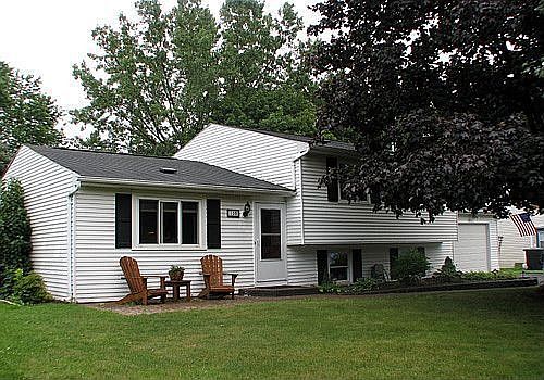 Street view with paver walkway and flower beds