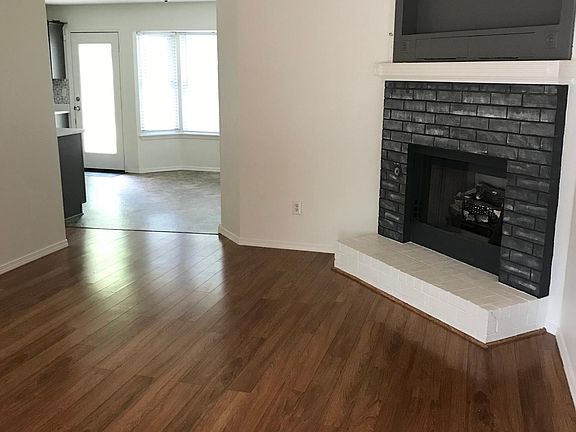 Gas log fireplace in living room.