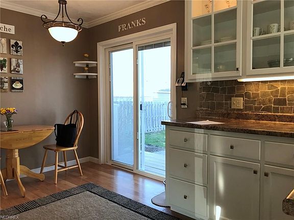 Gorgeous kitchen fully renovated to include sliding glass doors to Trex steps to a pretty patio and fully fenced backyard. All newer cabinetry with glass doors, newer light fixtures and pretty backsplash. All newer appliances (2015) for this renovated kit