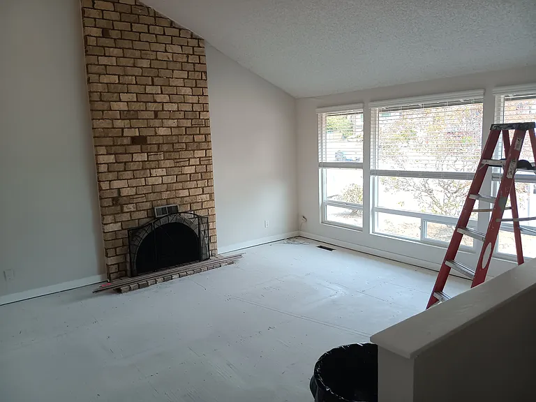 Living room with wood fire place.