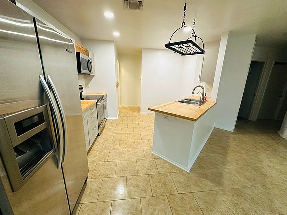 Kitchen from dinning room POV, has a separate faucet and filtration system from the sink that provides drinkable water.