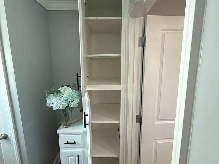 Laundry room cabinet storage space.