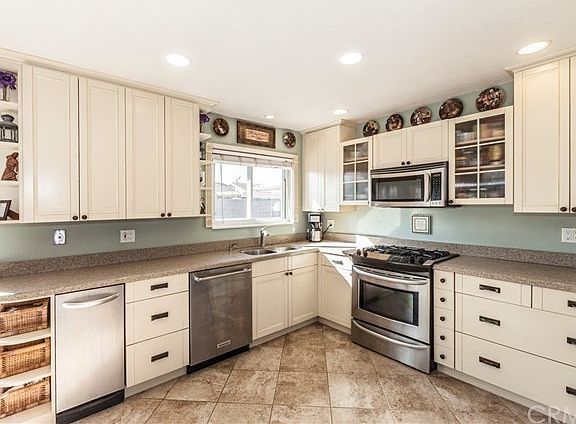 Cabinets are coffee glazed cream, door handles are French rubbed bronze.  Gas w/convection oven, microwave/convection oven combination, trash compactor, dishwasher all top-of-the line