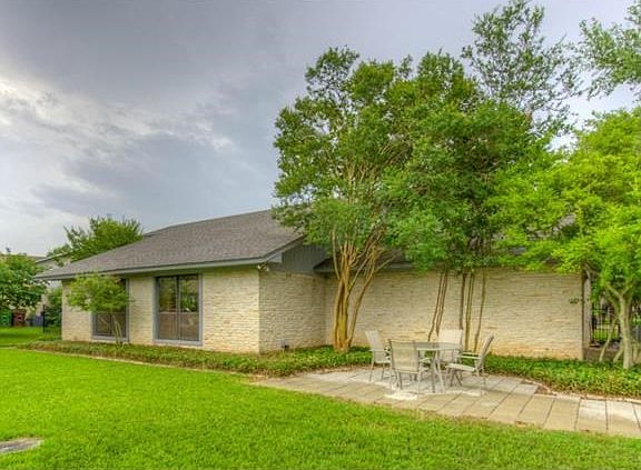 The house is recessed from the street and the lot is large enough to accommodate a patio in the front yard.