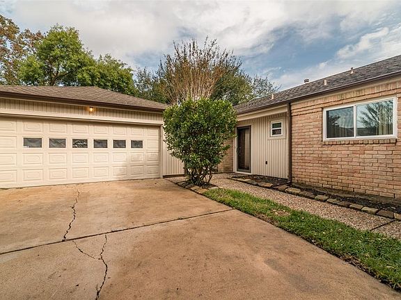 Extended double wide driveway has iron gate for added security