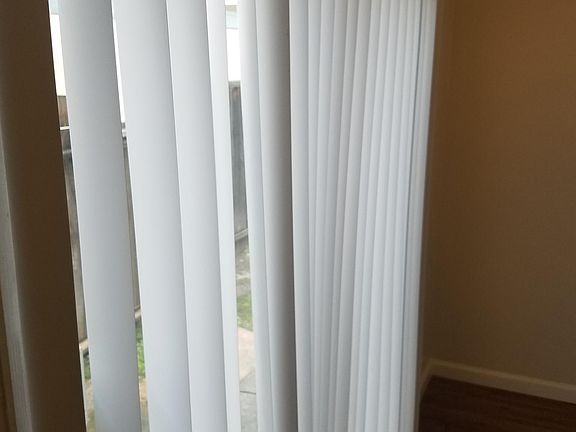 A big backyard is behind the sliding glass patio doors.