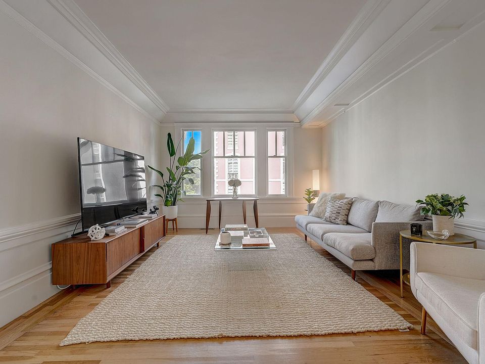 Grand but cozy living room overlooking Vallejo Street with soaring 12 ft ceilings and beautiful hardwood floors. There are also pocket doors from the living room to the dining room to close this room off, if needed.