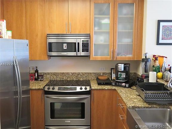Modern kitchen offers Stainless Steel appliances and Granite countertops.