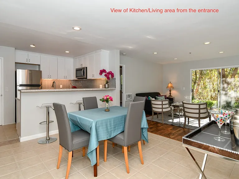 View of kitchen, dining, and living room from entrance