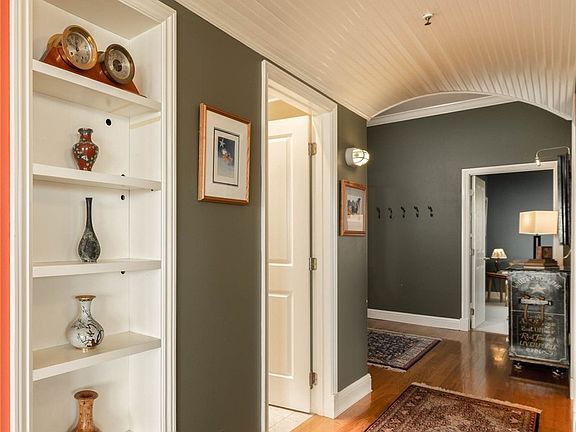 Facing north down the hall towards the master bed. Full hall bath on the left. Front entrance just beyond to the left. 